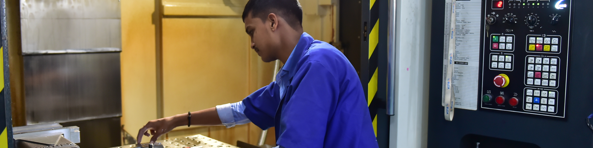 Technician operating a CNC machine